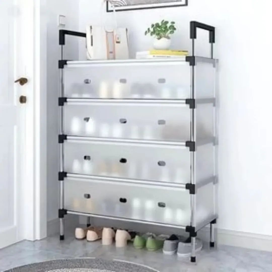Multi-tiered storage rack with transparent shelves and black handles in a room setting.